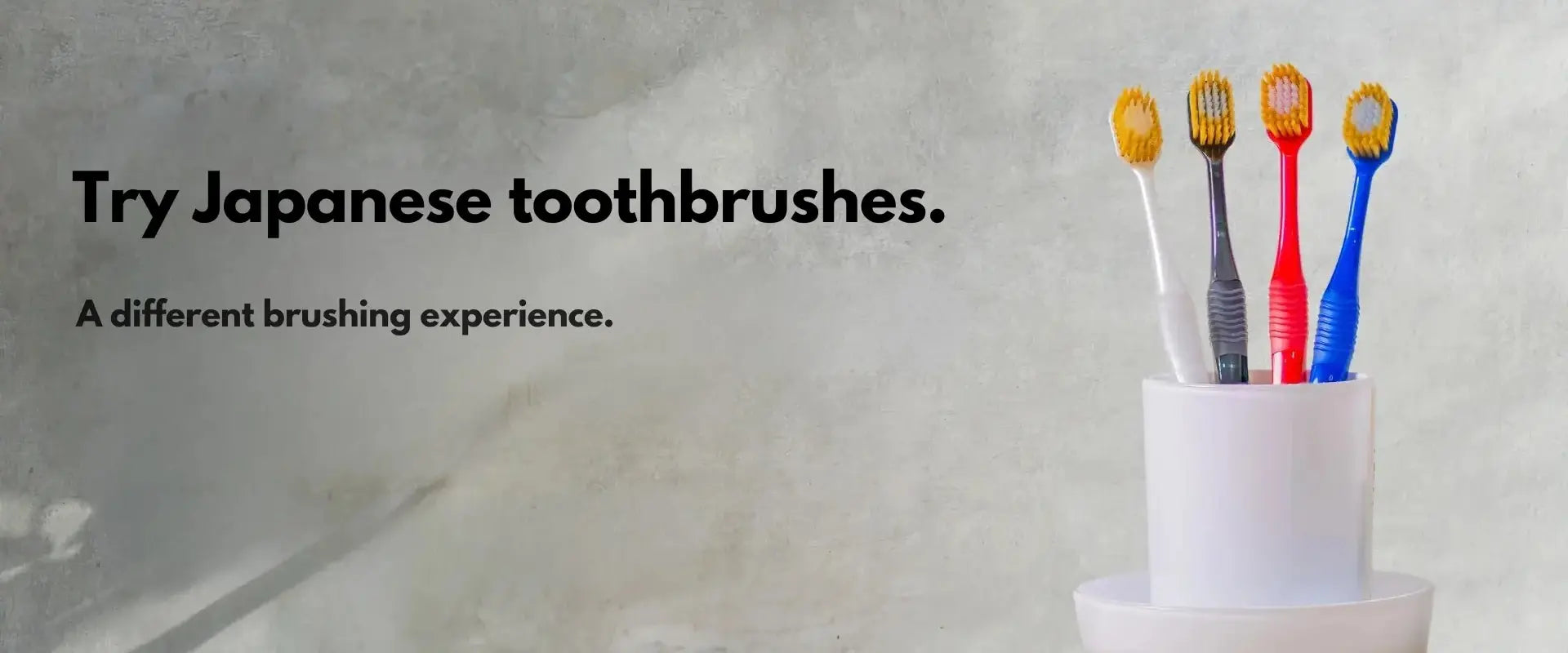 Japanese toothbrushes in a holder with compact heads and soft bristles, promoting a refined brushing experience in the UK